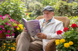 You reading the Spanish book on a plant-filled patio